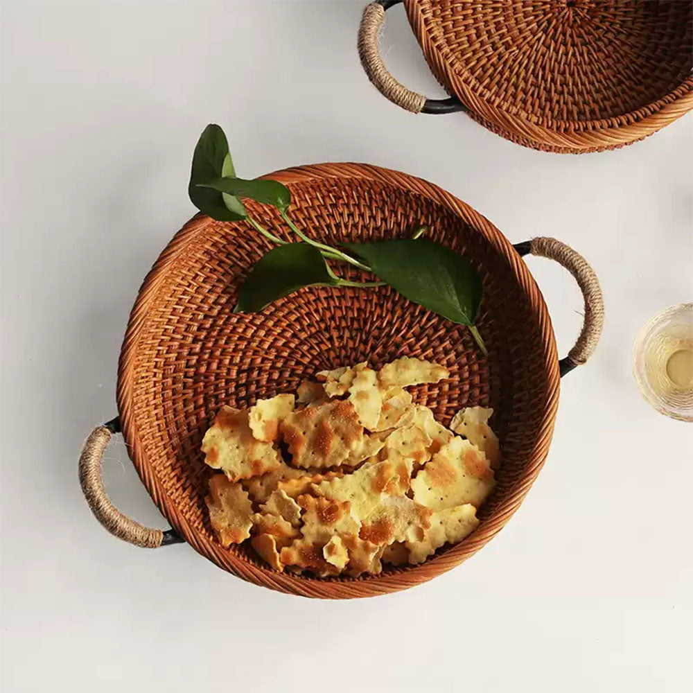 A round woven rattan basket with two side handles